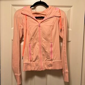 Lulu zip up coral hoodie with 2 front zipper pockets.